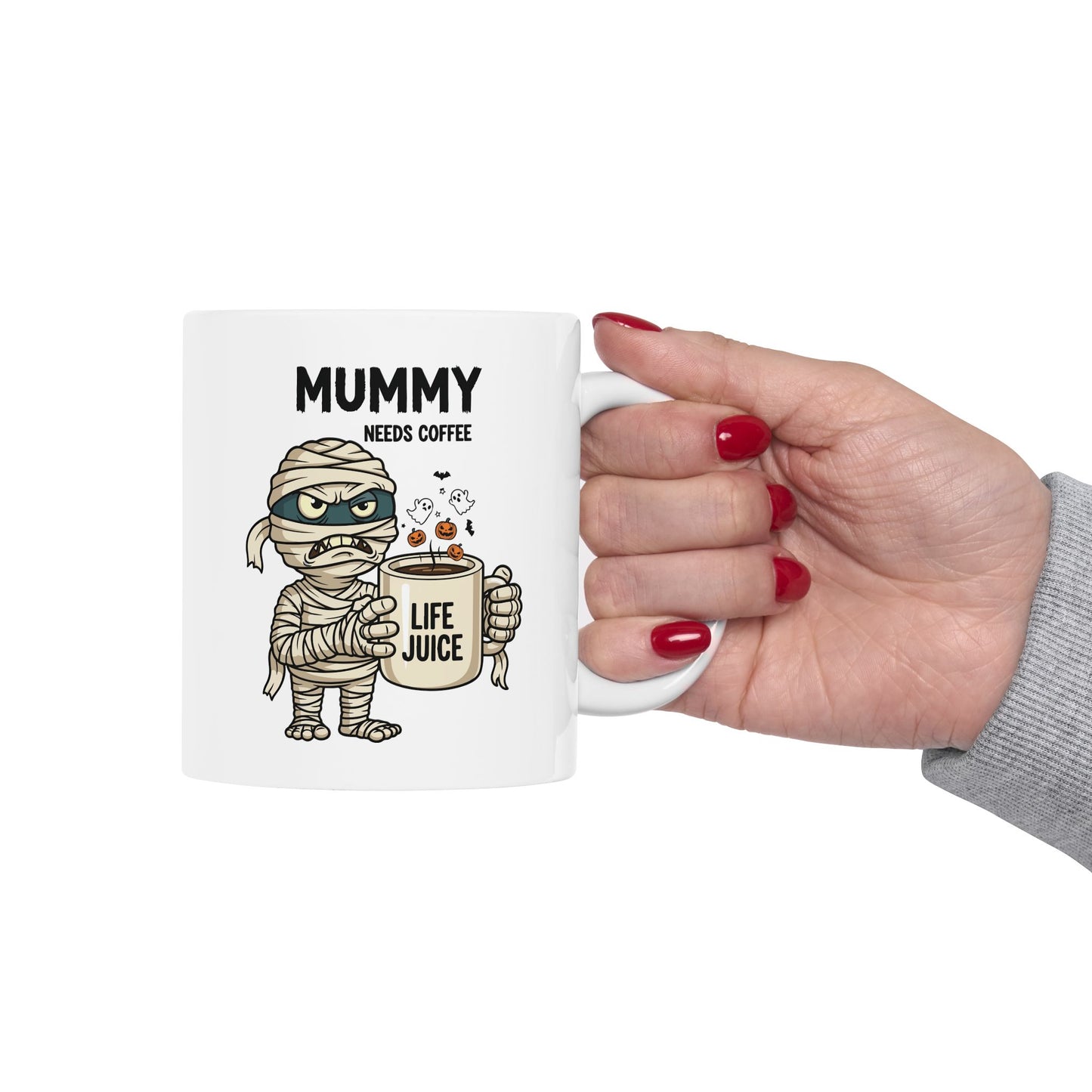 Halloween Mug with mummy design and text 'Mummy needs coffee' held by a hand.