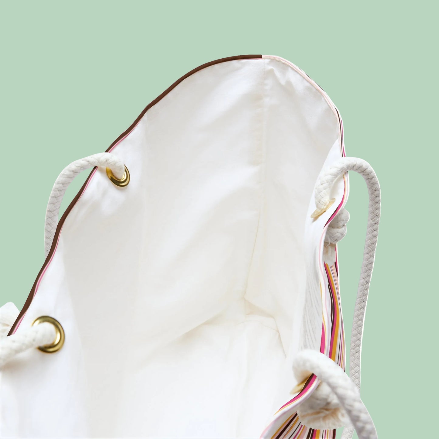 Large retro stripe weekender bag with rope handles in pink, amber and cream stripes