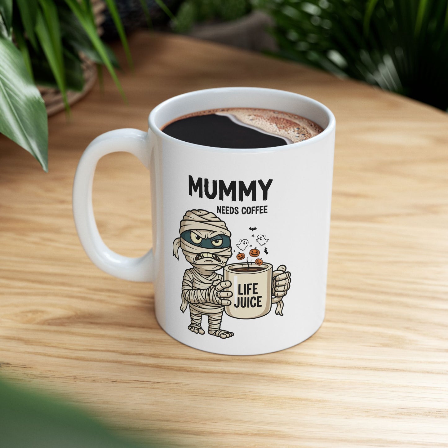 Halloween Mug with mummy design and text 'Mummy needs coffee' on a wooden surface.