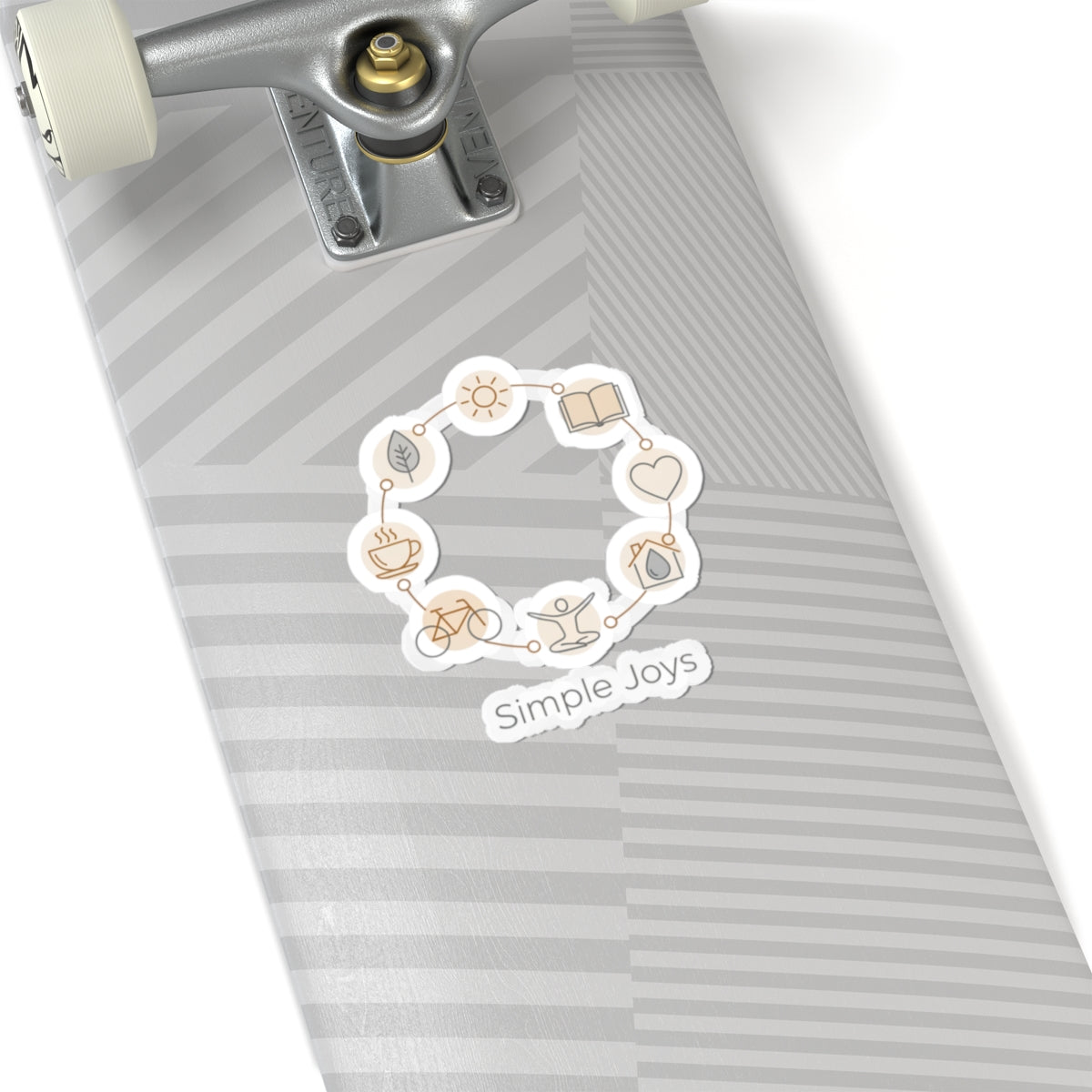 Skateboard with a 'Simple Joys' sticker on a white background