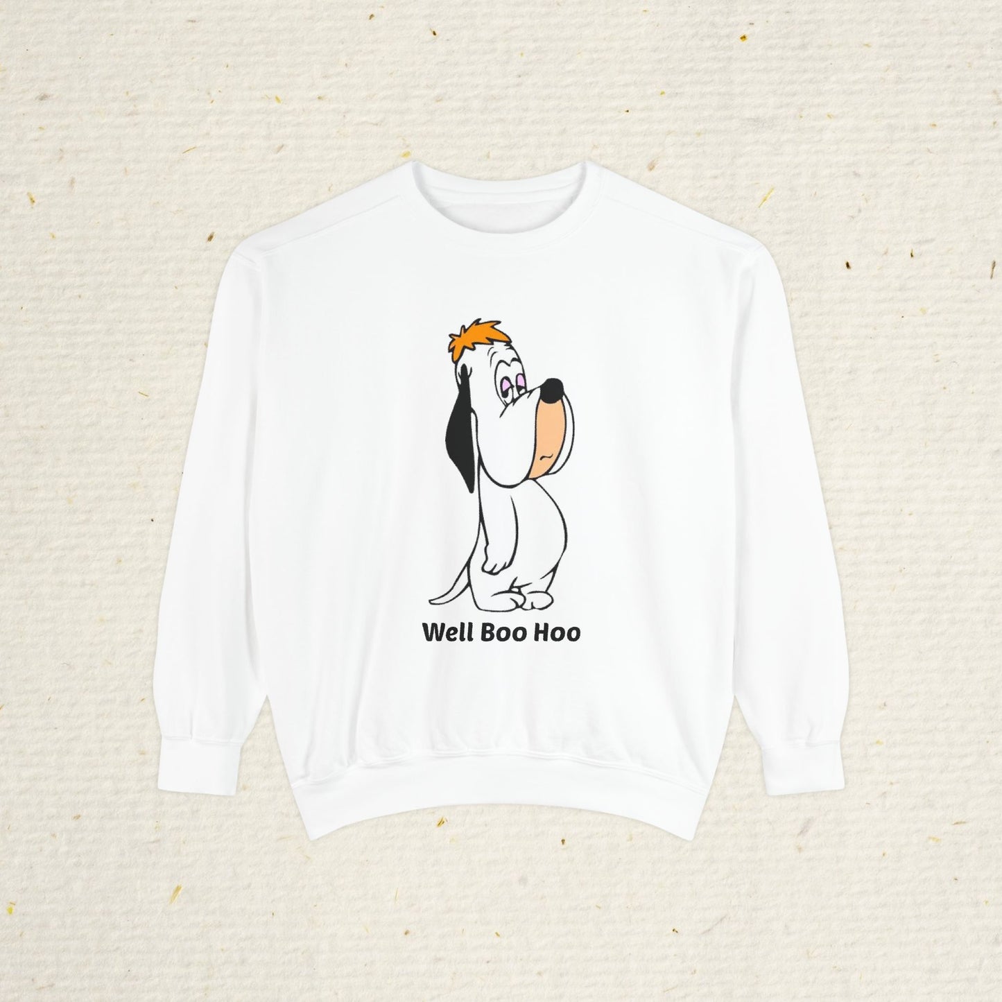 White sweatshirt with  cartoon droopy dog design and 'Well Boo Hoo' text on a beige background