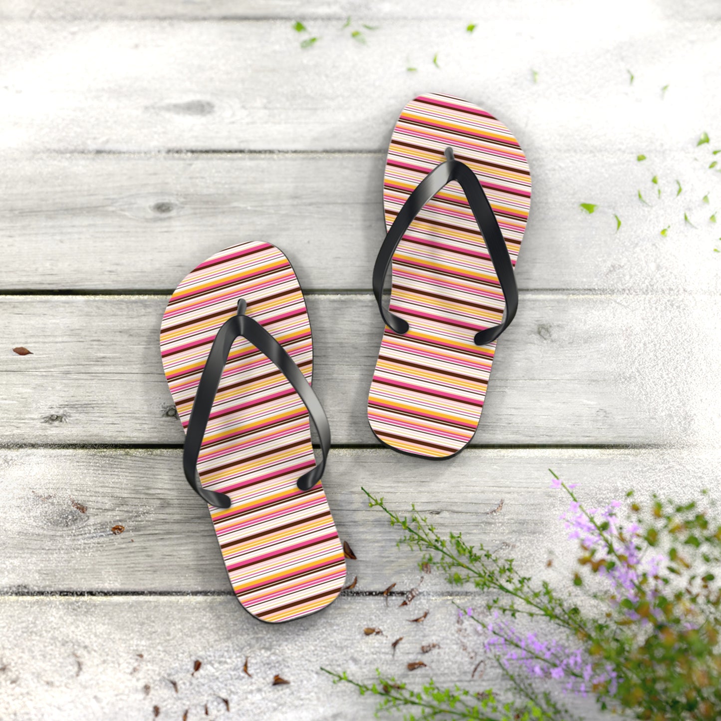 Women’s retro stripe flip flops with colorful 70s-inspired striped pattern and black straps on lightweight summer sandals.