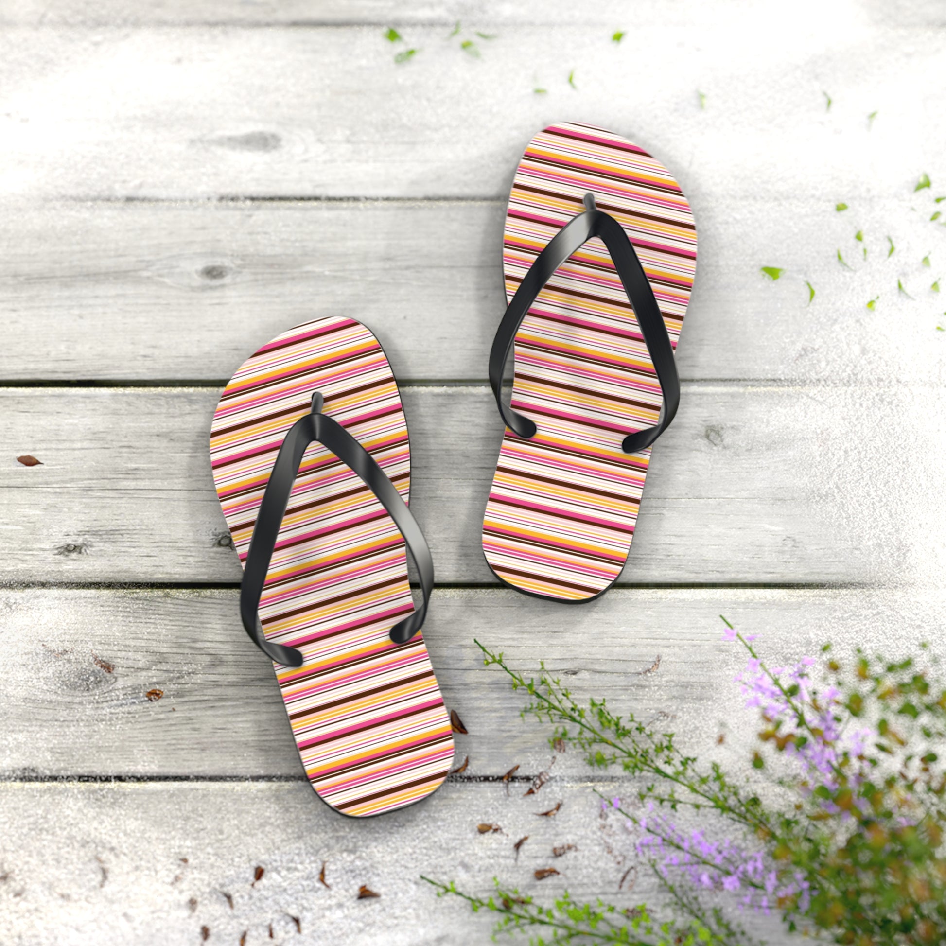 Women’s retro stripe flip flops with colorful 70s-inspired striped pattern and black straps on lightweight summer sandals.