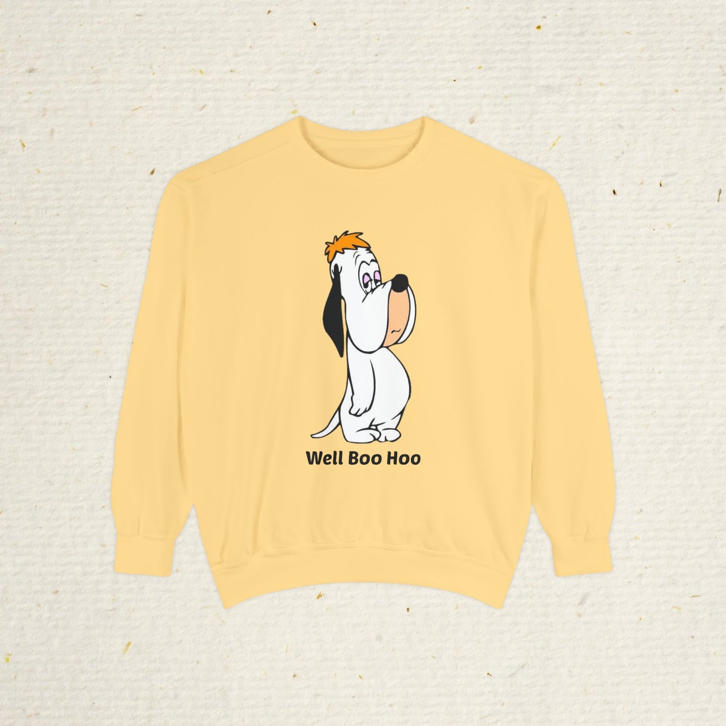 Yellow sweatshirt with cartoon droopy dog design and 'Well Boo Hoo' text on a beige background