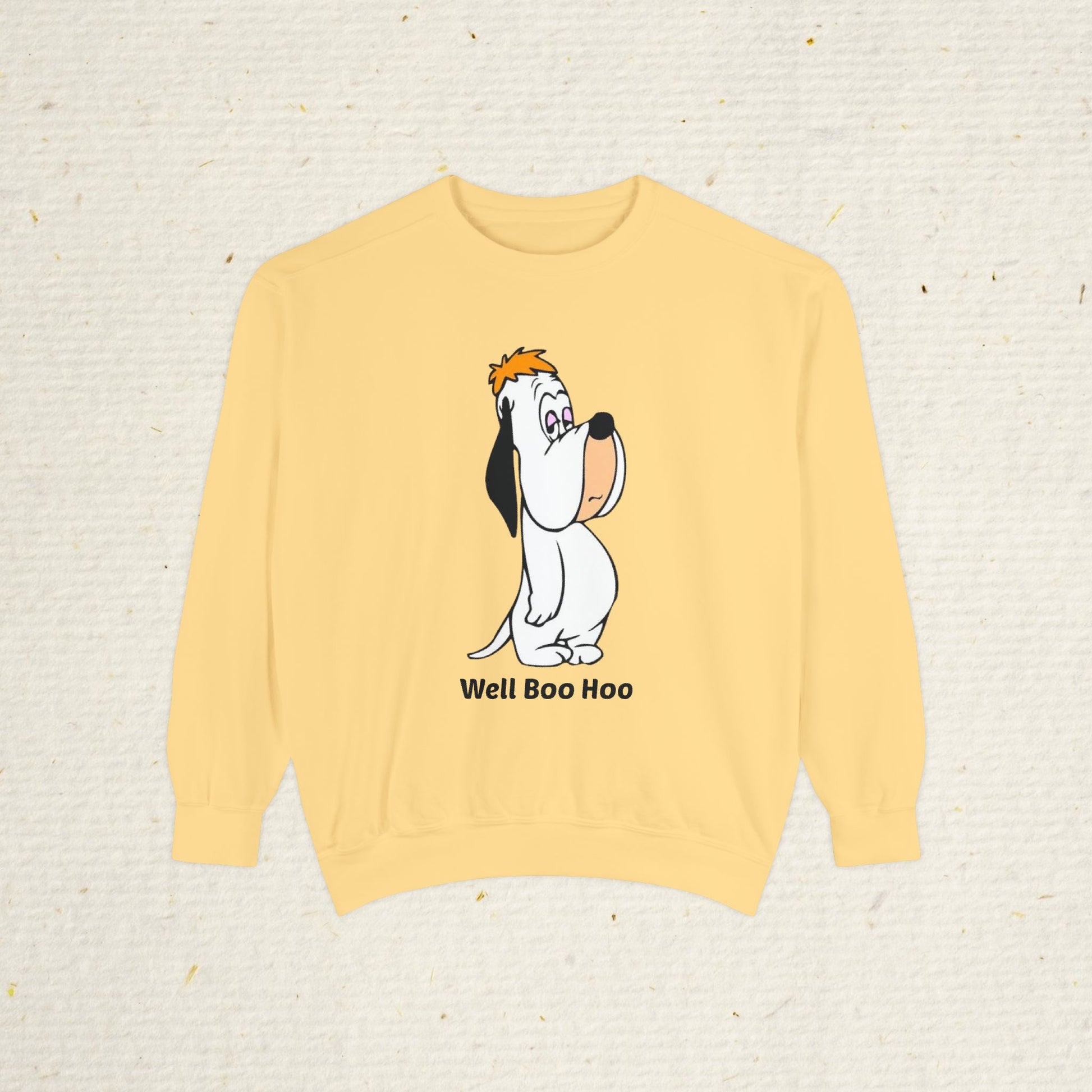 Yellow sweatshirt with cartoon droopy dog design and 'Well Boo Hoo' text on a beige background