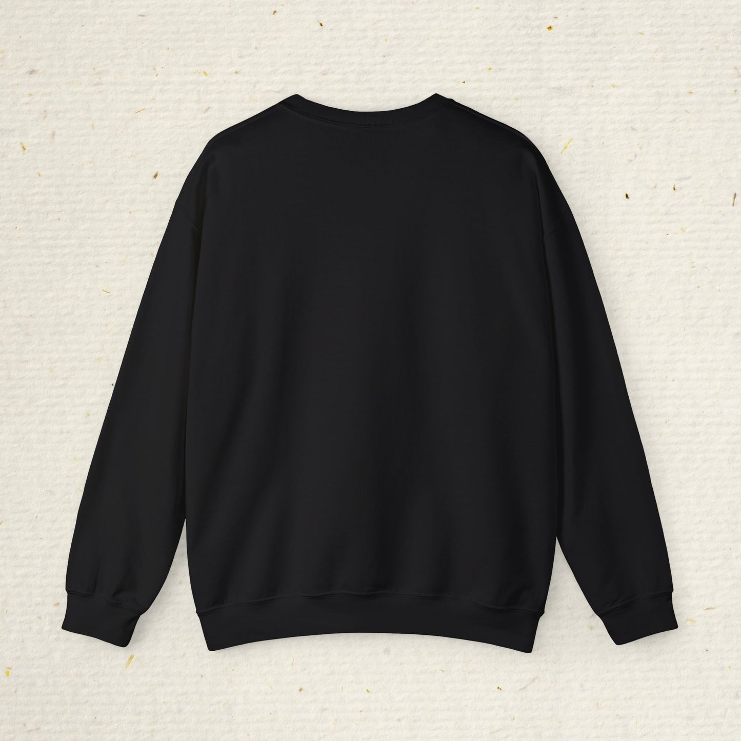 Black sweatshirt on a textured beige background