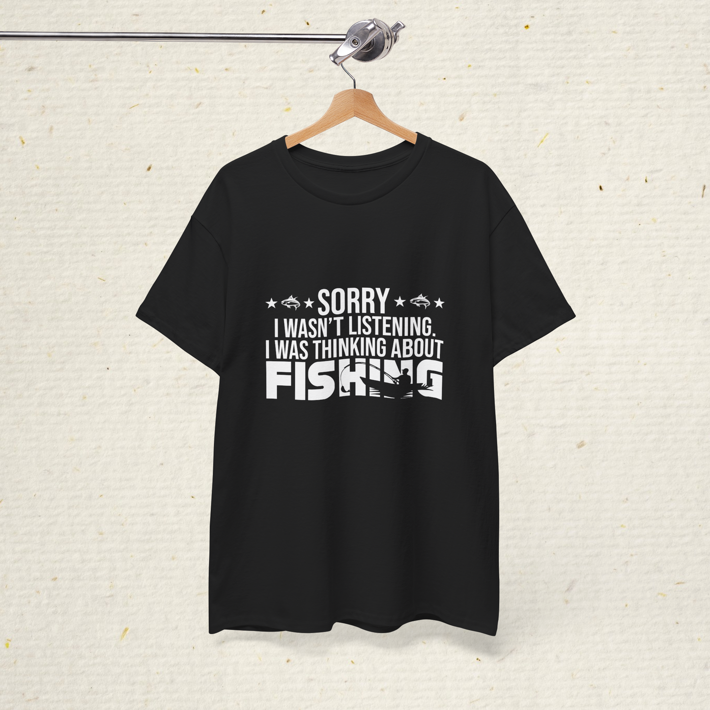 Men's fishing Black t-shirt with white text on a hanger against a textured white background