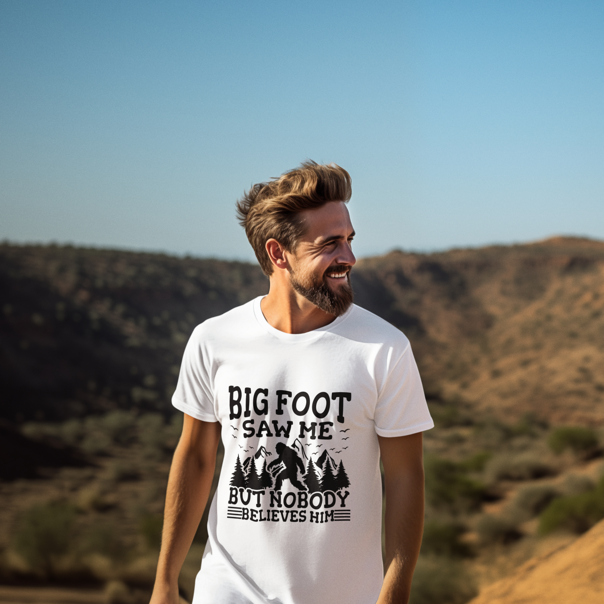 Man wearing a white t-shirt with 'Big Foot saw me but nobody believes him' text in a desert landscape.