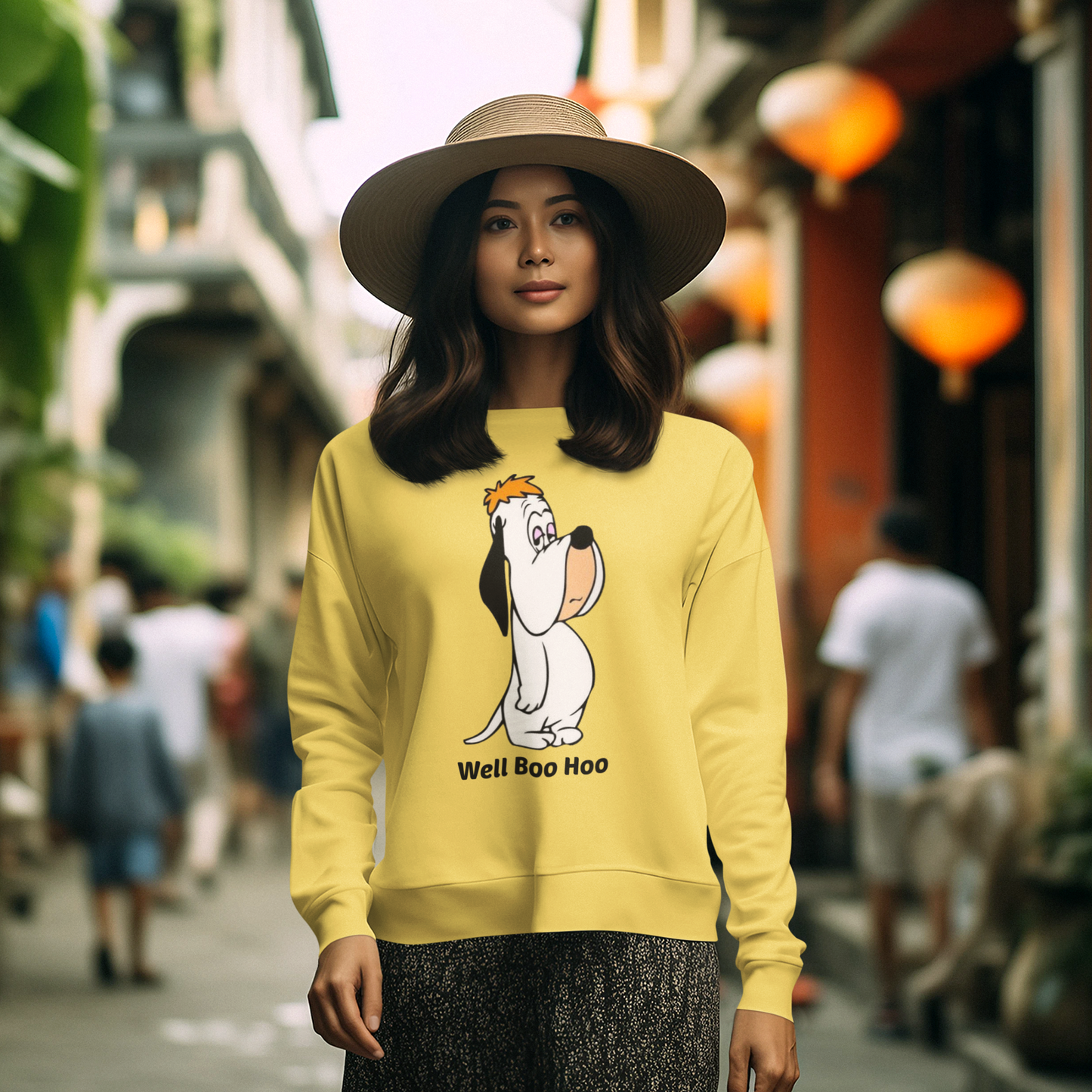 Woman wearing a yellow sweatshirt with a cartoon dog design in an outdoor setting.