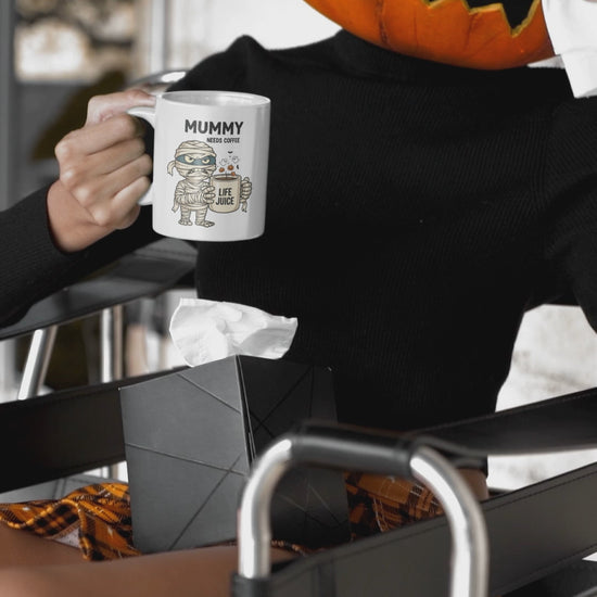 Halloween mug, mummy mug being used by a Halloween pumpkin momster.