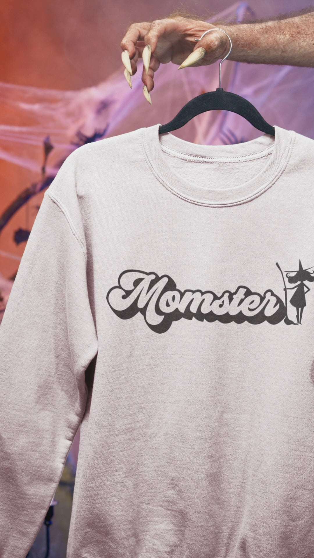 White sweatshirt with a Halloween witch 'Momster' design 