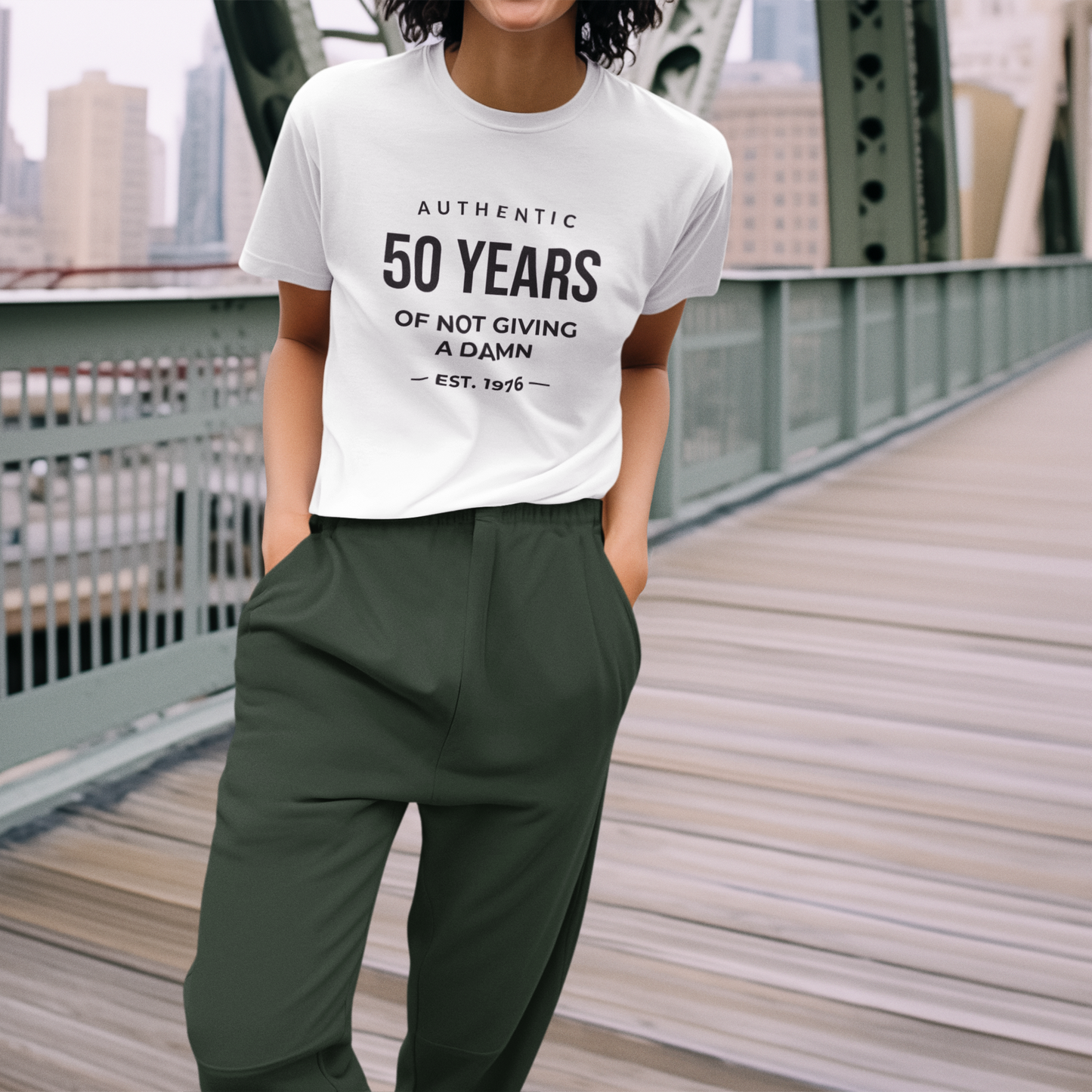 Women's funny 50th birthday t-shirt featuring Authentic 50 Years of Not Giving a Damn Est. 1976 graphic