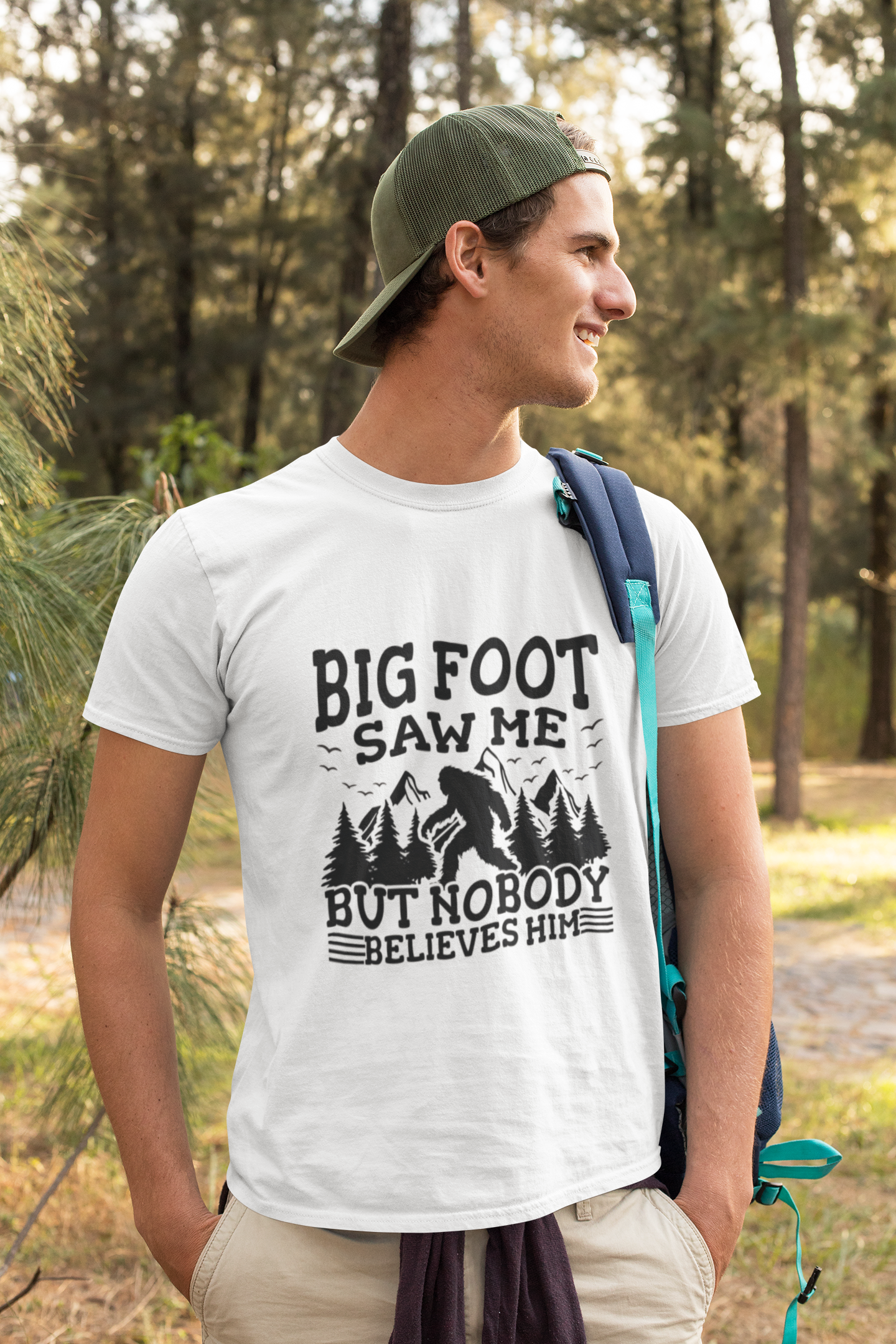 Person wearing a t-shirt with 'Big Foot saw me but nobody believes him' text outdoors.