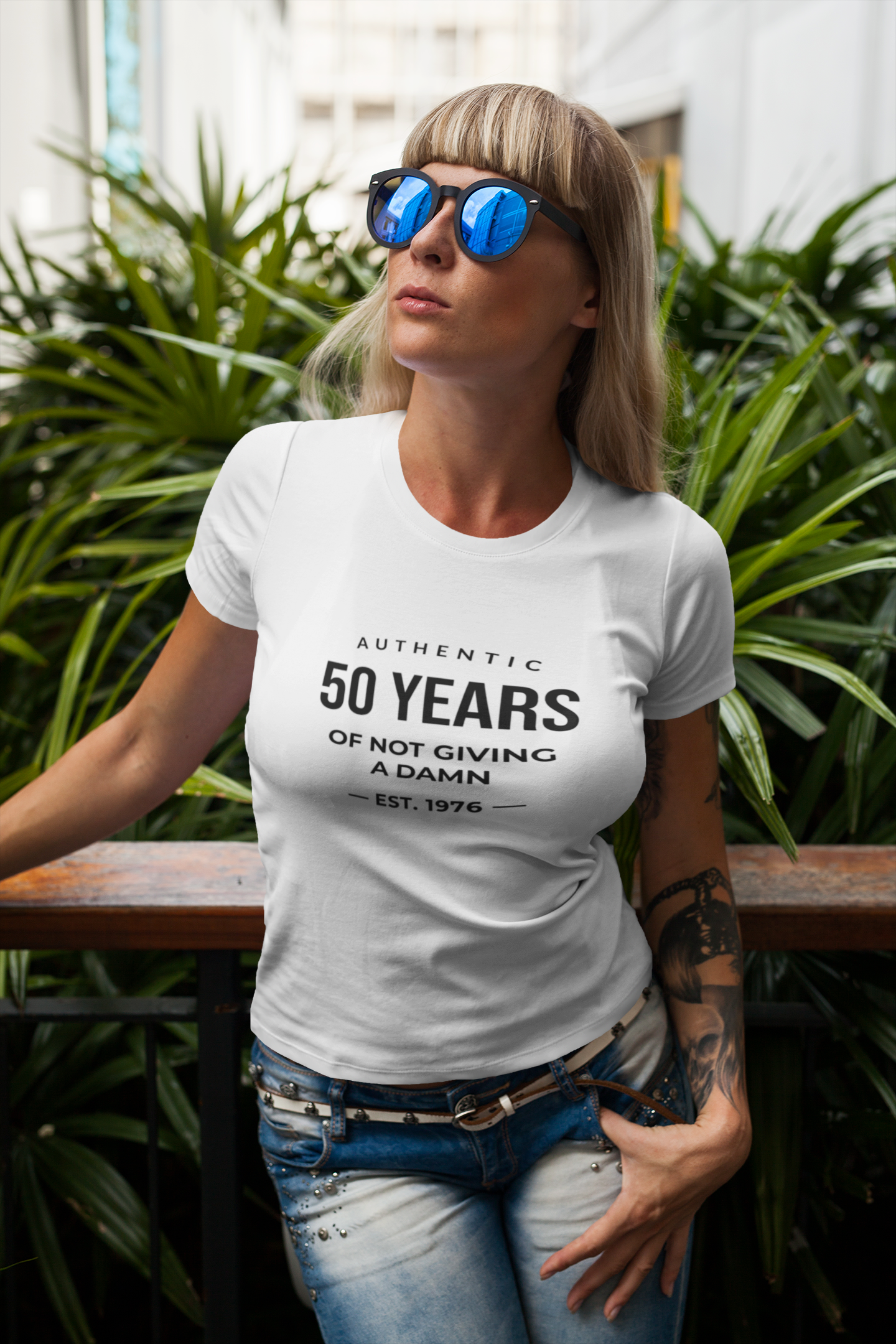 Women's funny 50th birthday t-shirt featuring Authentic 50 Years of Not Giving a Damn Est. 1976 graphic